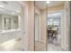Hallway mirrored wall reflects the bathroom on the left and the dining room to the right at 6209 Erice St, Venice, FL 34293