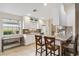 Kitchen boasts counter seating, white cabinets, and stainless steel appliances, creating a stylish and inviting atmosphere at 6209 Erice St, Venice, FL 34293