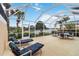 Screened lanai with lounge chairs, table, and view of the water at 6209 Erice St, Venice, FL 34293