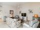 Bright and airy living room with comfortable seating, neutral walls, and a ceiling fan for a cozy atmosphere at 6209 Erice St, Venice, FL 34293
