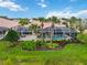 Screened-in pool, tropical landscaping, and outdoor space create a relaxing backyard oasis at 6209 Erice St, Venice, FL 34293