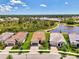 Aerial view of a lovely neighborhood with tree-lined streets and lush landscaping near water and preserves at 6267 Crested Eagle Ln, Nokomis, FL 34275
