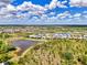 Aerial view showcasing a beautiful home with a terracotta roof, nestled among community lakes and greenery at 6267 Crested Eagle Ln, Nokomis, FL 34275