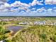 Overhead view highlighting the property's location within a scenic community featuring lakes and lush landscapes at 6267 Crested Eagle Ln, Nokomis, FL 34275