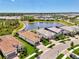 Panoramic aerial view of several homes in a residential community with lakes, preserves, and mature landscaping at 6267 Crested Eagle Ln, Nokomis, FL 34275