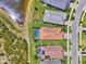 Aerial view of property with screened pool backing up to lake, offering privacy and scenic views at 6267 Crested Eagle Ln, Nokomis, FL 34275