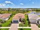 Aerial view of home with a tile roof, manicured lawn, and peaceful water views at 6267 Crested Eagle Ln, Nokomis, FL 34275