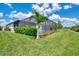 Expansive backyard featuring a screened lanai, tropical landscaping, and lush green lawn, offering serene outdoor living at 6267 Crested Eagle Ln, Nokomis, FL 34275