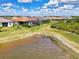 A peaceful backyard view showcases the property's proximity to the lake, offering serene waterfront living at 6267 Crested Eagle Ln, Nokomis, FL 34275