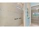 Modern bathroom featuring a tiled shower with a sleek glass enclosure and convenient grab bars at 6267 Crested Eagle Ln, Nokomis, FL 34275