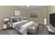 Stylishly furnished bedroom featuring a cozy bed, chic decor, and a bright window view at 6267 Crested Eagle Ln, Nokomis, FL 34275