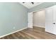 Bedroom featuring hardwood flooring and direct access to a closet via an open double-door entryway at 6267 Crested Eagle Ln, Nokomis, FL 34275