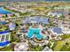 Aerial view of a resort-style community pool with ample seating, lush landscaping, and recreational amenities at 6267 Crested Eagle Ln, Nokomis, FL 34275