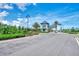 Elegant community entrance with lush landscaping and decorative gatehouse at 6267 Crested Eagle Ln, Nokomis, FL 34275