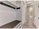 Inviting entryway with a built-in bench, coat hooks, and vinyl plank flooring at 6267 Crested Eagle Ln, Nokomis, FL 34275