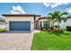 Charming single-Gathering home featuring a paver driveway, well-manicured lawn, and a welcoming facade at 6267 Crested Eagle Ln, Nokomis, FL 34275