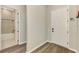 Entryway featuring hardwood floors and views to the bathroom at 6267 Crested Eagle Ln, Nokomis, FL 34275