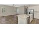 Open concept kitchen with stainless steel appliances, island, and a view into the living room at 6267 Crested Eagle Ln, Nokomis, FL 34275