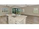 Modern kitchen with a large island, stainless steel appliances, and plenty of natural light at 6267 Crested Eagle Ln, Nokomis, FL 34275