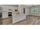 Modern kitchen with stainless steel appliances and a large island, perfect for entertaining and meal preparation at 6267 Crested Eagle Ln, Nokomis, FL 34275