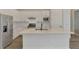Stylish kitchen boasts stainless steel appliances, quartz countertops, and a center island with seating at 6267 Crested Eagle Ln, Nokomis, FL 34275
