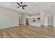 Bright kitchen with stainless appliances, quartz countertops, and island flows into the living area at 6267 Crested Eagle Ln, Nokomis, FL 34275