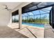 Spacious covered lanai with a swimming pool, beautiful landscaping, and a lake view at 6267 Crested Eagle Ln, Nokomis, FL 34275