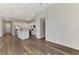 Open-concept living room showcasing luxury plank flooring, shiplap accent wall and seamless flow into the kitchen at 6267 Crested Eagle Ln, Nokomis, FL 34275