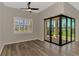 Bright living room with luxury plank flooring and multi-panel sliding doors to the screened lanai at 6267 Crested Eagle Ln, Nokomis, FL 34275