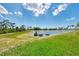 Scenic backyard with a picturesque pond, offering a tranquil and natural view at 6267 Crested Eagle Ln, Nokomis, FL 34275