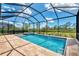 Gorgeous screened-in pool with spa, pavers, and beautiful landscaping at 6267 Crested Eagle Ln, Nokomis, FL 34275