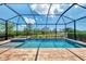 Sparkling pool and spa with a screened enclosure offering beautiful views of the surrounding landscape at 6267 Crested Eagle Ln, Nokomis, FL 34275