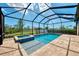 Screened-in pool and spa overlooking the lush backyard and serene water views at 6267 Crested Eagle Ln, Nokomis, FL 34275