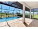 Screened-in lanai featuring a swimming pool with a sun shelf and lush landscaping at 6267 Crested Eagle Ln, Nokomis, FL 34275