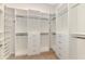 Walk-in closet with ample shelving, drawers, and rods to maximize storage and organization at 6267 Crested Eagle Ln, Nokomis, FL 34275