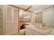 Tiled bathroom with glass block shower, vanity, and mirrored medicine cabinets for ample storage at 6267 Midnight Pass Rd # 306, Sarasota, FL 34242