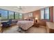 Comfortable bedroom featuring bright windows, neutral walls, and wood floors at 6267 Midnight Pass Rd # 306, Sarasota, FL 34242