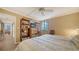 Comfortable bedroom with a bookshelf, view of the hallway, and a cozy queen bed at 6267 Midnight Pass Rd # 306, Sarasota, FL 34242