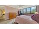 Cozy bedroom featuring bright windows, neutral walls, and ample closet space at 6267 Midnight Pass Rd # 306, Sarasota, FL 34242