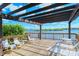 Community deck overlooking the water, furnished with lounge chairs at 6267 Midnight Pass Rd # 306, Sarasota, FL 34242