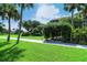 Lush green lawn, manicured bushes and palm trees add to the beauty of the community at 6267 Midnight Pass Rd # 306, Sarasota, FL 34242