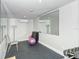 Exercise room featuring weights, exercise ball, mirrored wall, and air conditioning at 6267 Midnight Pass Rd # 306, Sarasota, FL 34242