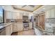 Well-equipped kitchen with stainless steel appliances, mosaic backsplash, and cozy breakfast area at 6267 Midnight Pass Rd # 306, Sarasota, FL 34242