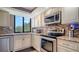 Well-appointed kitchen featuring stainless steel appliances and granite countertops at 6267 Midnight Pass Rd # 306, Sarasota, FL 34242