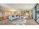 Open living room area with stylish furniture, built-in shelving, and access to the balcony at 6267 Midnight Pass Rd # 306, Sarasota, FL 34242