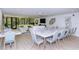 A spacious lounge area with modern furnishings, a large window, and a dining table with seating for 10 at 6267 Midnight Pass Rd # 306, Sarasota, FL 34242
