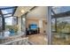 Inviting sunroom with floor-to-ceiling windows, creating a bright and airy living space with a comfortable seating area at 6267 Midnight Pass Rd # 306, Sarasota, FL 34242