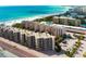 Aerial view of several buildings with a beach and Gulf of Mexico as the back drop at 6480 Midnight Pass Rd # 315, Sarasota, FL 34242