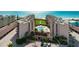 Aerial view of a community with a swimming pool with a background of the beach and Gulf of Mexico at 6480 Midnight Pass Rd # 315, Sarasota, FL 34242