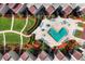 Aerial view of a community pool and lush landscaping among beachfront condos and tropical foliage at 6480 Midnight Pass Rd # 315, Sarasota, FL 34242